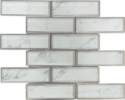 Carrara Bianco 2x6 Metal Tile is composed of Brick Pattern and chips. It is a natural marble Stone Polished. It has a border with Metal to contrast the white color - Tiles and Deco