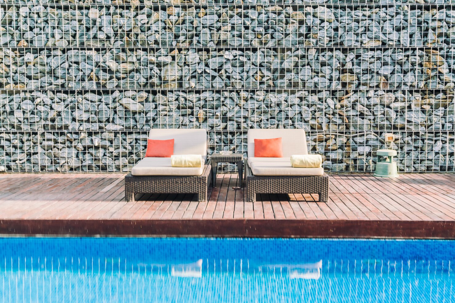 Stylish poolside tiles with modern outdoor seating area 